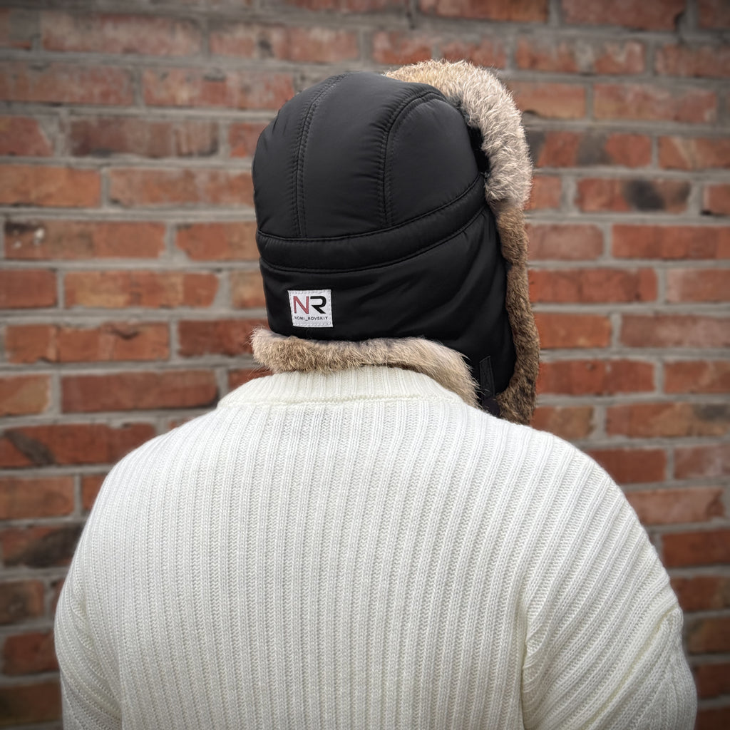 Back view of men's black ushanka hat showing the insulated outer shell